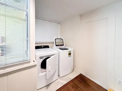 a living room with furniture a window and a chandelier