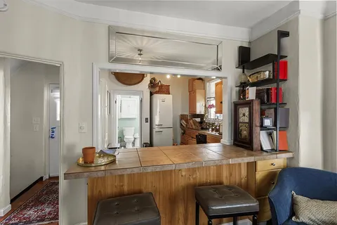 a living room with furniture fireplace and a window