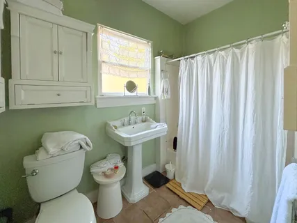 a bedroom with a large tub next to a large window