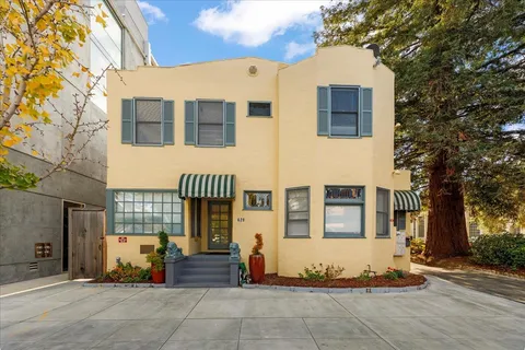 a living room with stainless steel appliances furniture and a view of kitchen