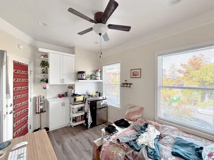 a bedroom with a bed and a window