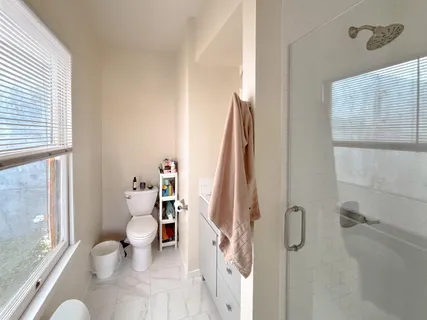 a bathroom with a sink toilet and shower