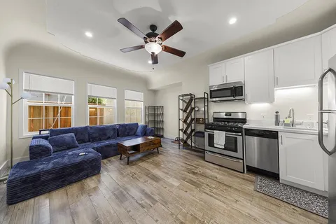 a living room with furniture and a large window