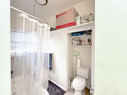 a kitchen with granite countertop white cabinets a sink dishwasher and a stove with wooden floor