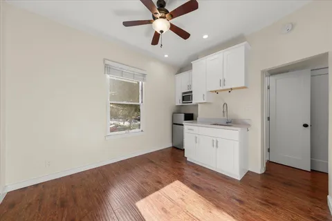 a bathroom with a granite countertop sink a mirror and a shower