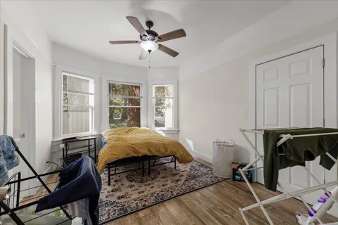 a kitchen with stainless steel appliances a stove a refrigerator cabinets and wooden floor