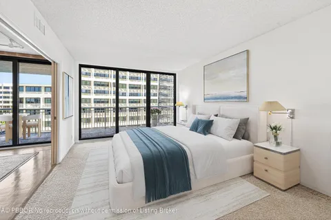 a bedroom with a large bed and a large window