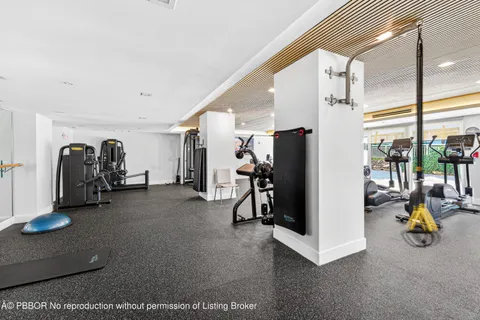 a room with pool table and couches with wooden floor