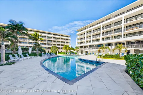 a view of swimming pool with outdoor seating and plants