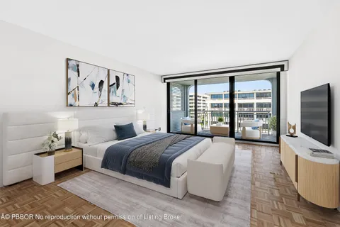 a spacious bedroom with a bed and a flat screen tv