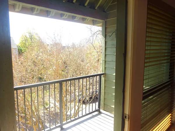 a view of a balcony with wooden floor