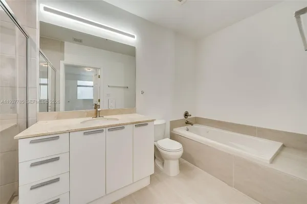 a bathroom with a toilet a sink and bathtub