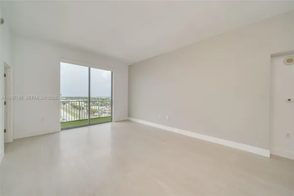 an empty room with large windows