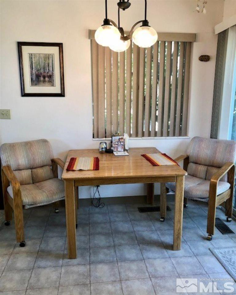 10220 Pathfinder Drive Reno, NV 89508 - Photo 13 of 36 a room with furniture a table and chairs