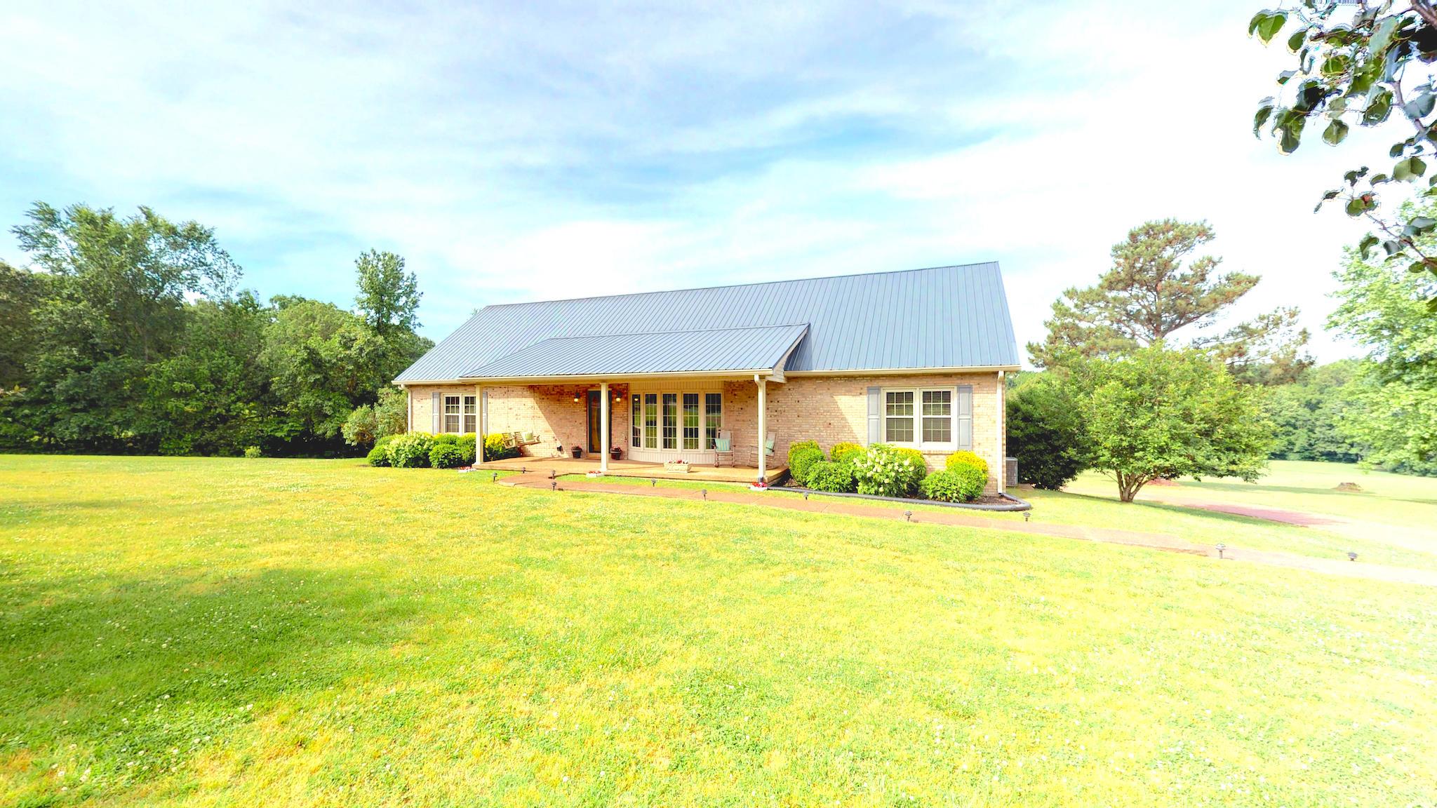7209 Crow Cut Road Fairview, TN 37062 - Photo 1 of 30 a front view of house and outdoor space with swimming pool and trees in the background