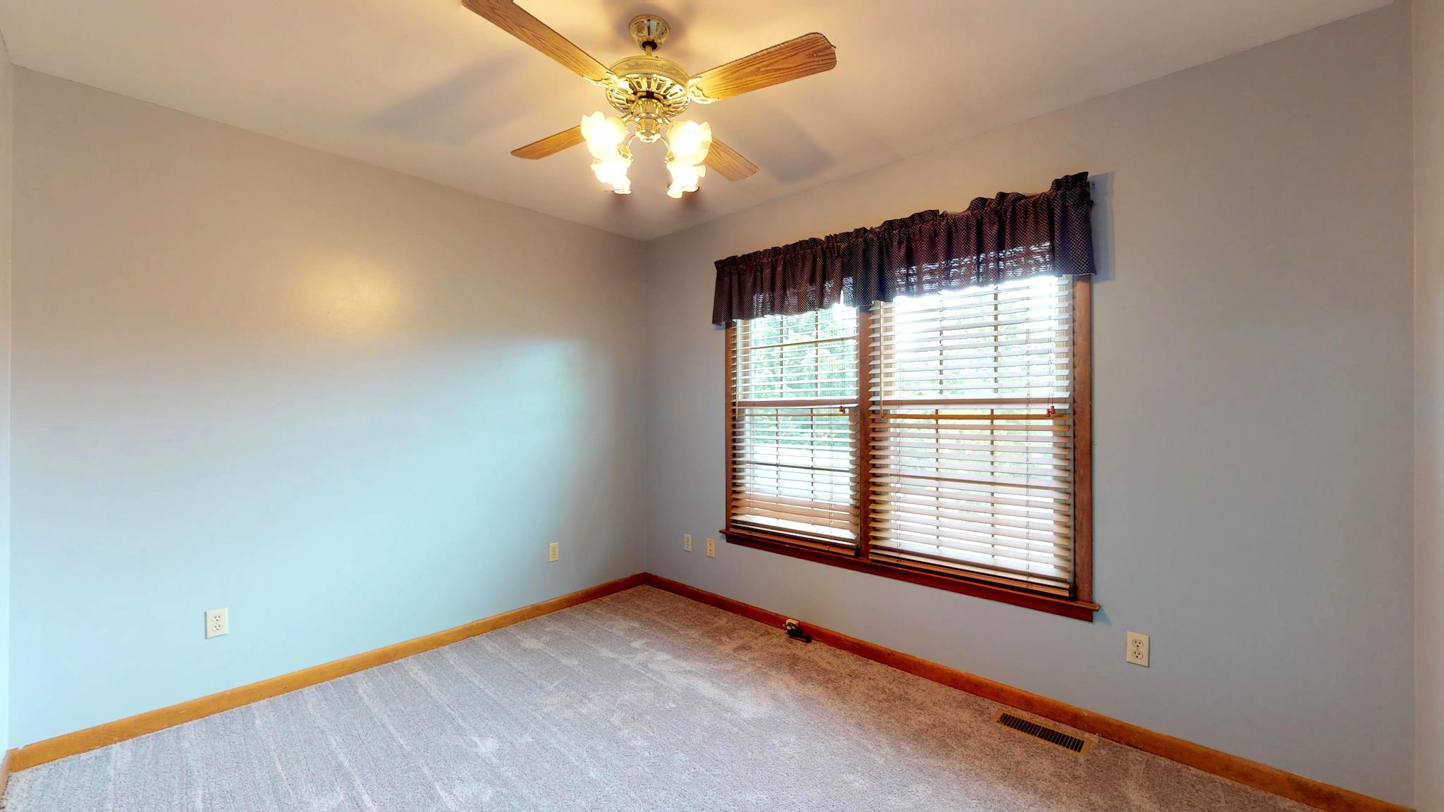 7209 Crow Cut Road Fairview, TN 37062 - Photo 16 of 30 an empty room with windows and fan