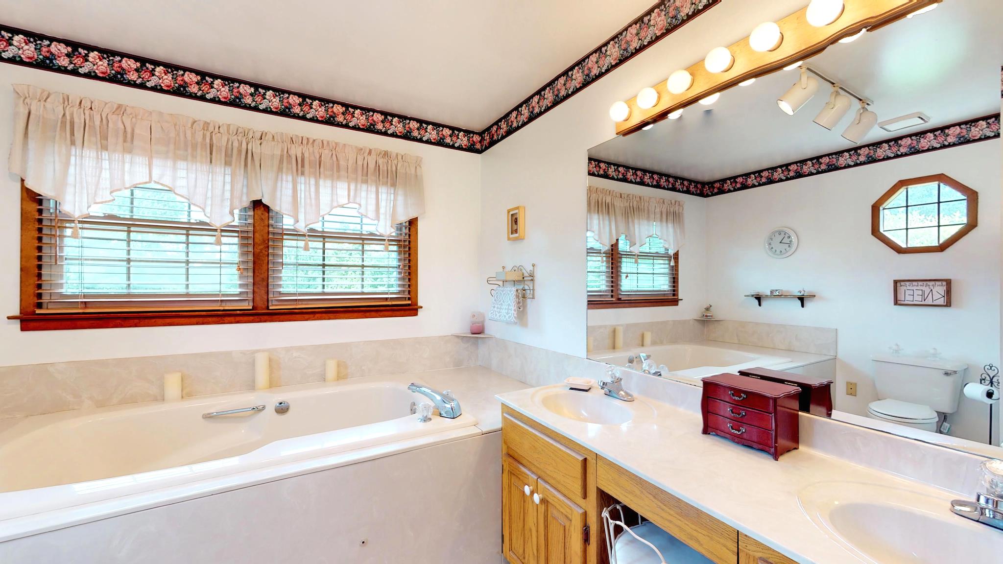 7209 Crow Cut Road Fairview, TN 37062 - Photo 20 of 30 a bathroom with a double vanity sink and a bathtub