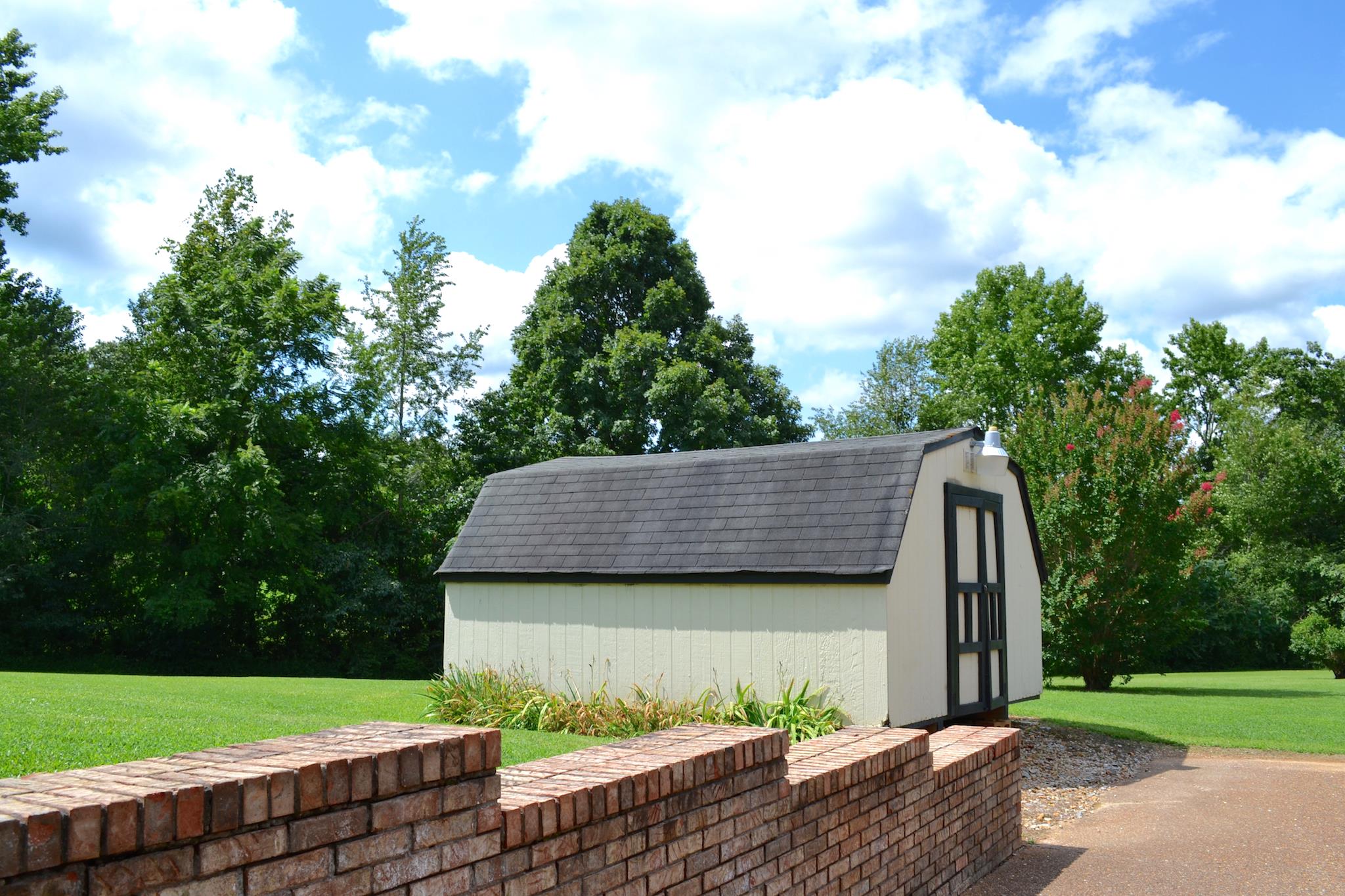7209 Crow Cut Road Fairview, TN 37062 - Photo 26 of 30 a view of a wooden house next to a yard