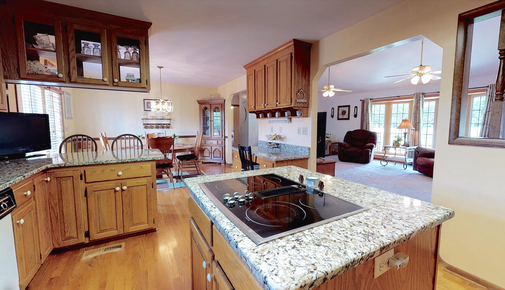 7209 Crow Cut Road Fairview, TN 37062 - Photo 7 of 30 a kitchen with stainless steel appliances granite countertop a stove a sink and a wooden cabinets