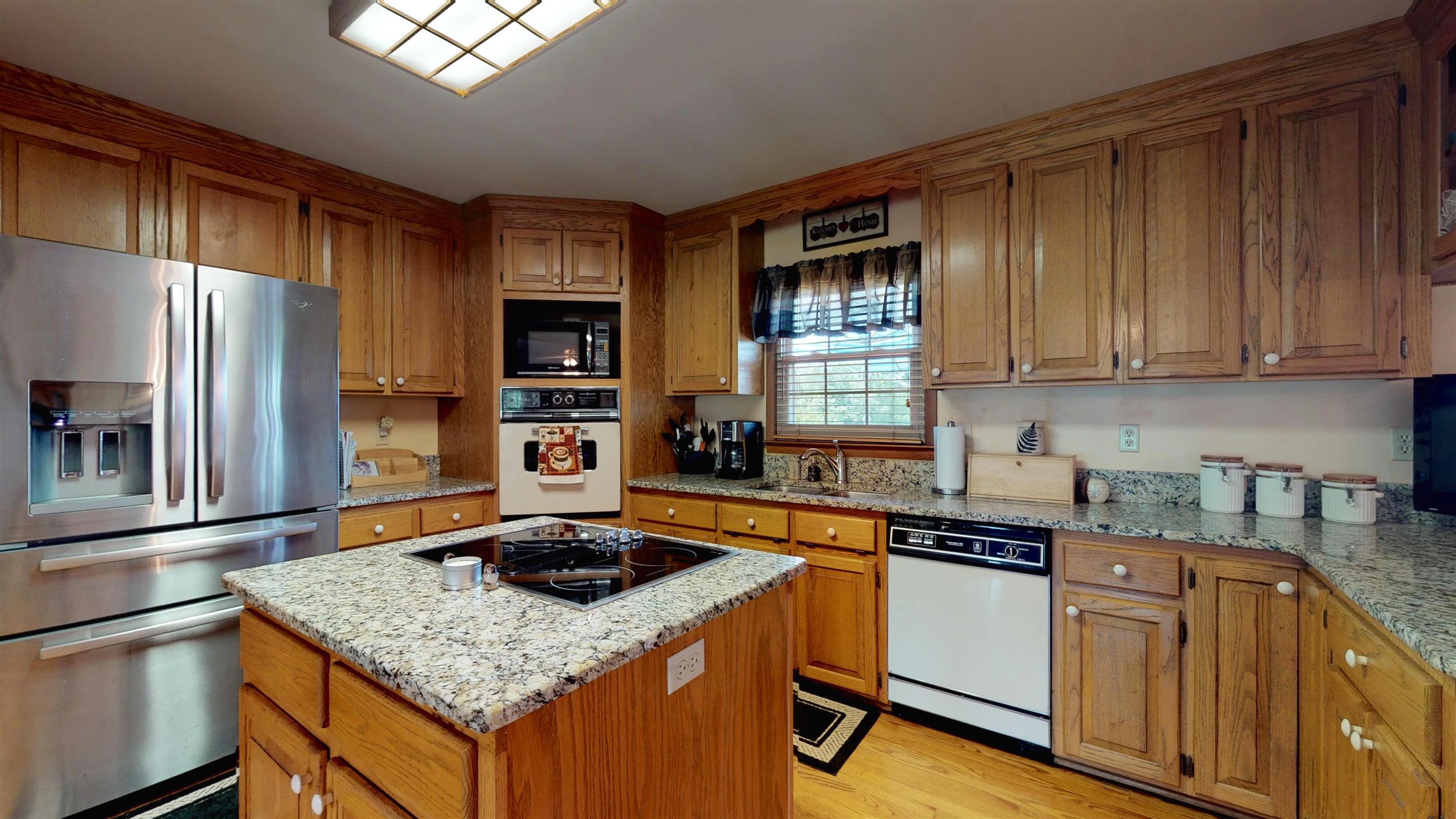 7209 Crow Cut Road Fairview, TN 37062 - Photo 8 of 30 a kitchen with stainless steel appliances granite countertop a sink stove and refrigerator