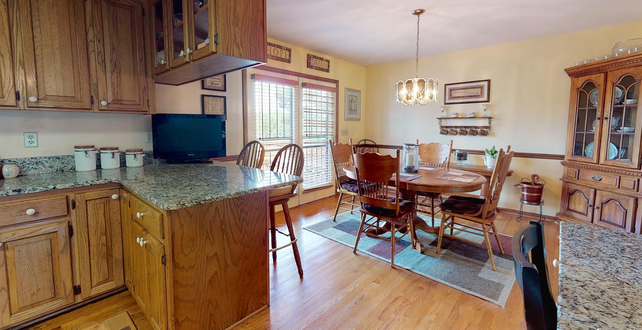 7209 Crow Cut Road Fairview, TN 37062 - Photo 9 of 30 a view of a dining room with furniture window and wooden floor
