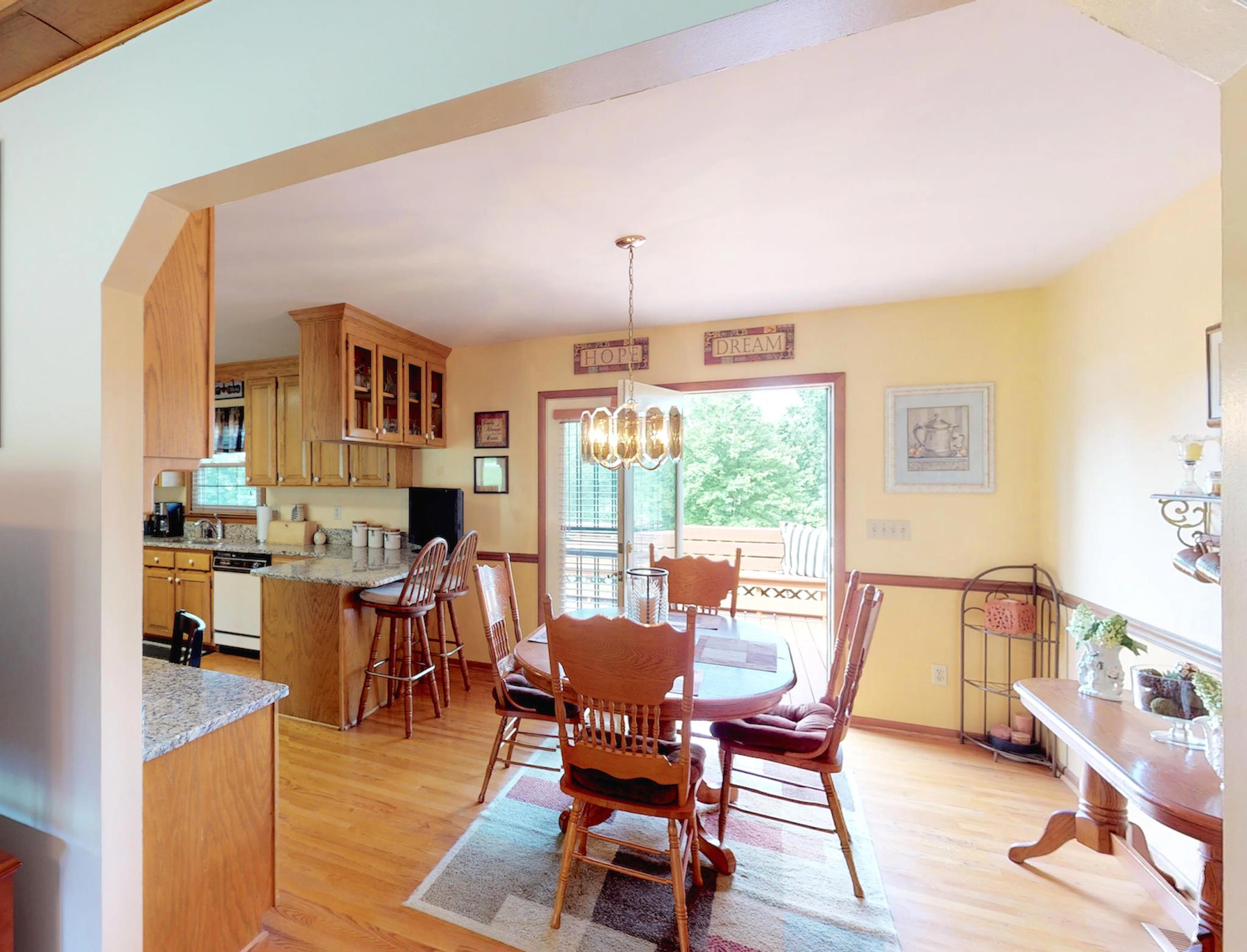 7209 Crow Cut Road Fairview, TN 37062 - Photo 10 of 30 a dining room with furniture a chandelier and wooden floor