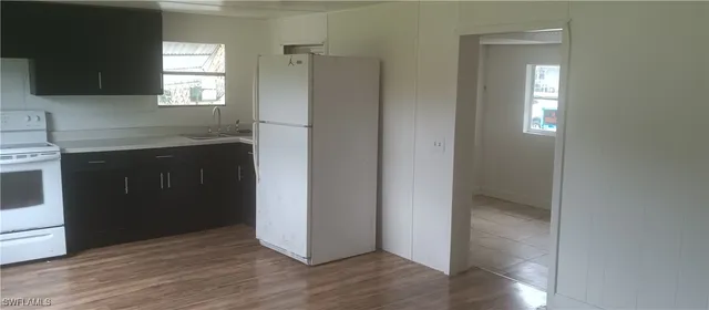 a kitchen with a refrigerator and window