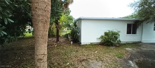 a view of a house with a tree in the background