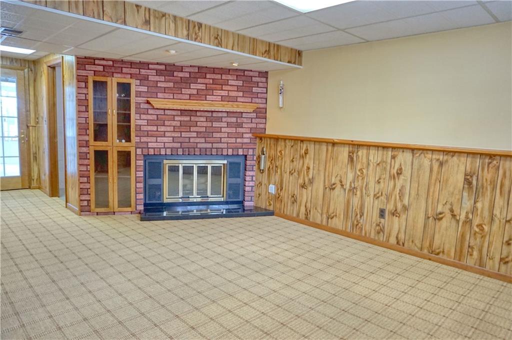 101 Walney Road Butler, PA 16002 - Photo 21 of 25 Lower level family room with wood burning fireplace and entrance to the four seasons room!