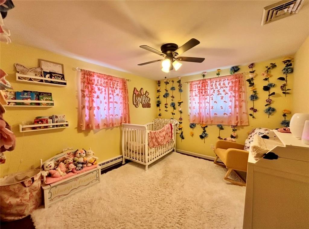 87 McMichael Road Carnegie, PA 15106 - Photo 7 of 20 a spacious bedroom with a bed and a chandelier