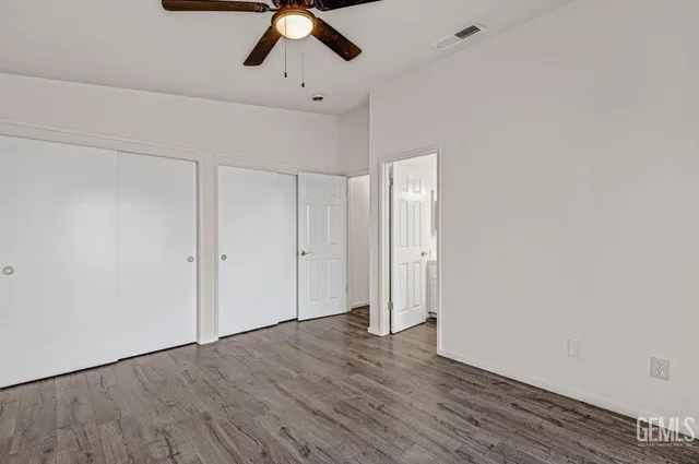 a view of an empty room and wooden floor