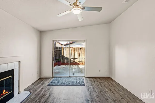 a view of a livingroom with wooden floor and a ceiling fan