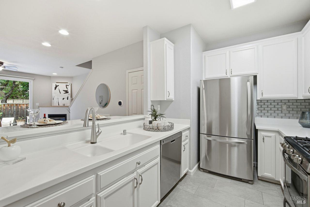 384 Mark West Commons Circle Santa Rosa, CA 95403 - Photo 12 of 44 a kitchen with appliances a sink and cabinets