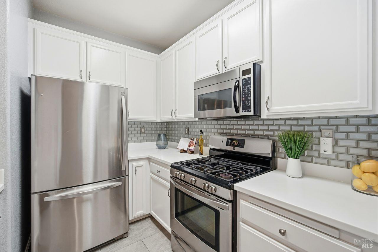 384 Mark West Commons Circle Santa Rosa, CA 95403 - Photo 13 of 44 a kitchen with appliances a refrigerator and cabinets