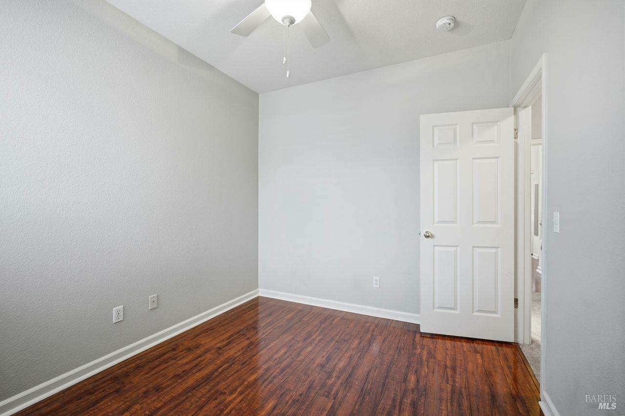384 Mark West Commons Circle Santa Rosa, CA 95403 - Photo 37 of 44 an empty room with wooden floor and windows