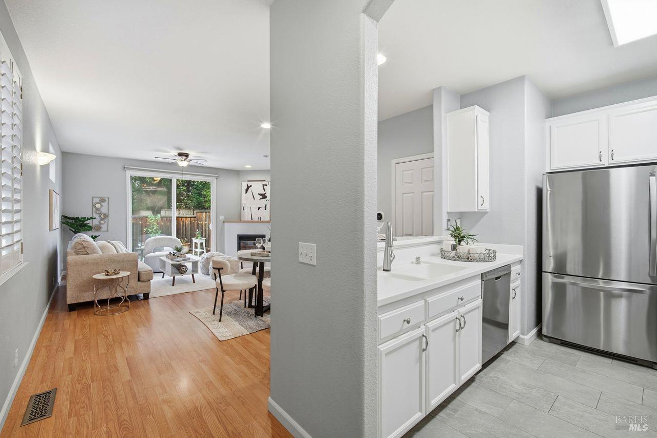 384 Mark West Commons Circle Santa Rosa, CA 95403 - Photo 4 of 44 a kitchen with white cabinets and stainless steel appliances