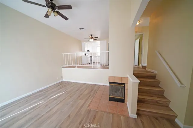 a view of a kitchen with wooden floor and electronic appliances