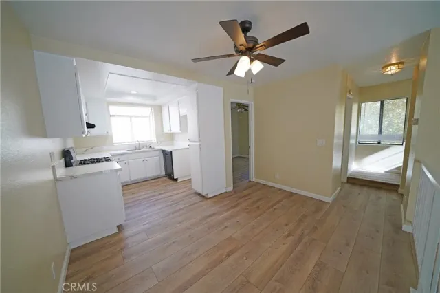 a view of empty room with wooden floor and window