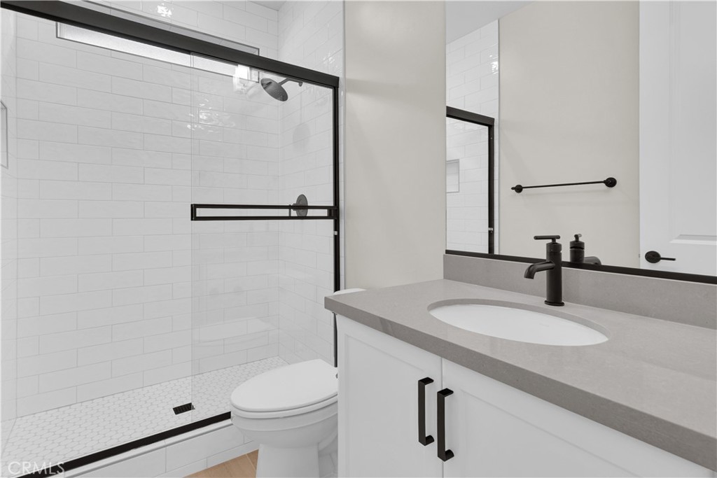 3730 Rosado Road Paso Robles, CA 93446 - Photo 13 of 17 a bathroom with a sink a toilet and a mirror