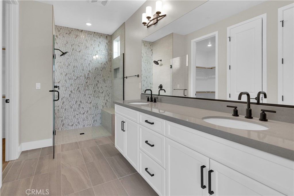 3730 Rosado Road Paso Robles, CA 93446 - Photo 10 of 17 a spacious bathroom with a granite countertop sink a toilet a shower and a mirror