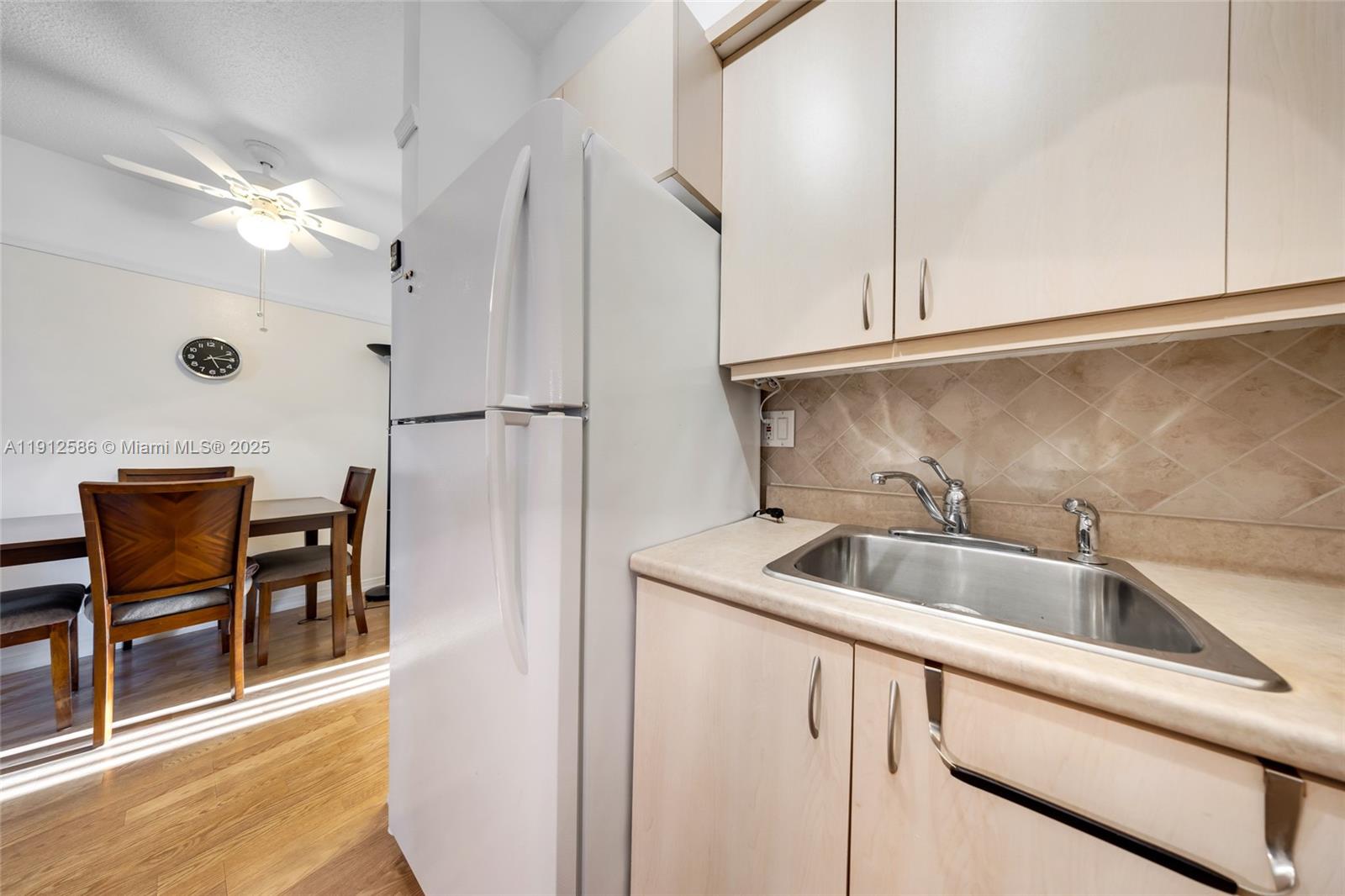 900 Southwest 10th Terrace, Unit 8S Hallandale Beach, FL 33009 - Photo 11 of 33 a kitchen with stainless steel appliances granite countertop a sink and a refrigerator