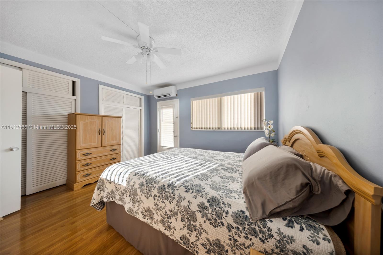 900 Southwest 10th Terrace, Unit 8S Hallandale Beach, FL 33009 - Photo 14 of 33 a bedroom with a bed and a refrigerator