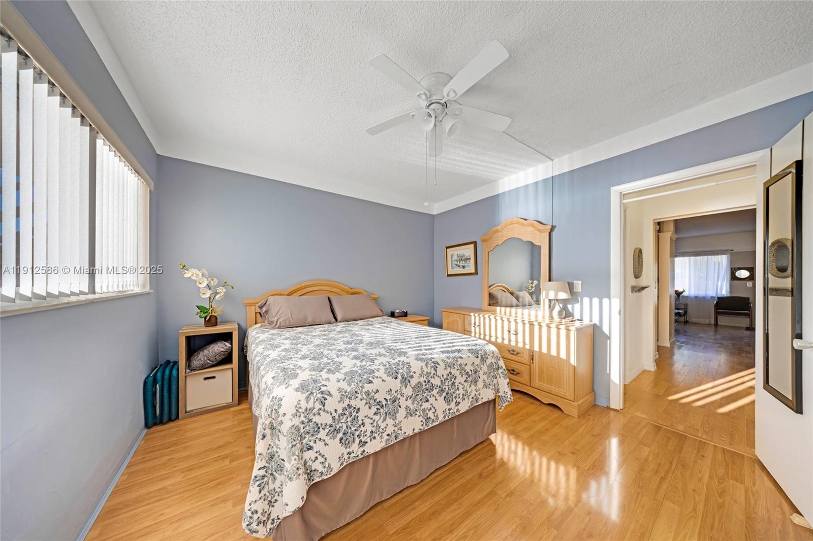 900 Southwest 10th Terrace, Unit 8S Hallandale Beach, FL 33009 - Photo 15 of 33 a bedroom with a bed and dresser with large mirror