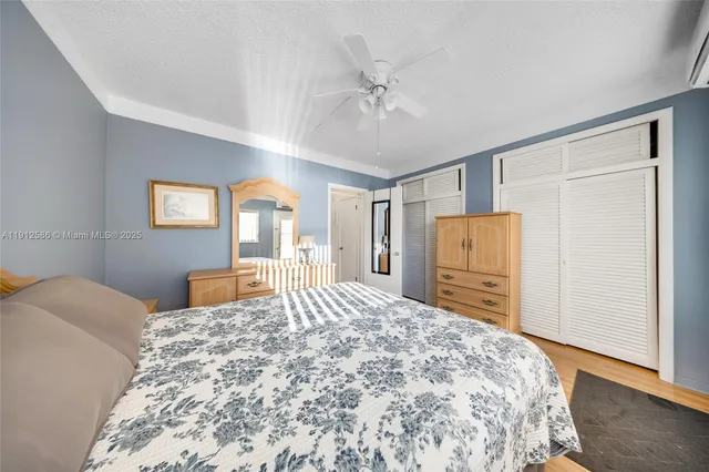 a bedroom with a bed and a refrigerator