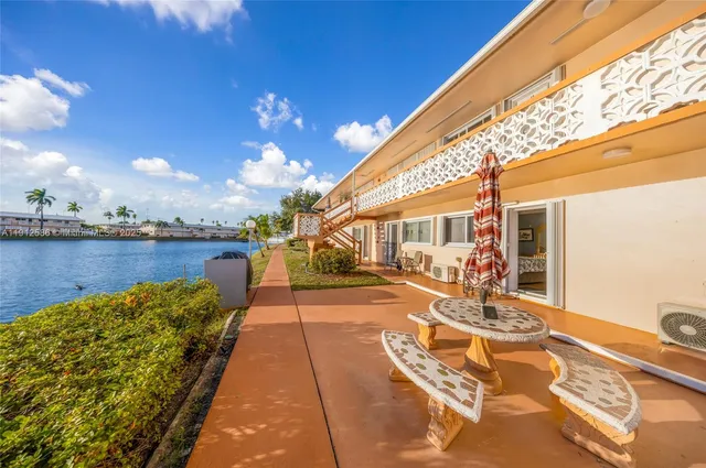 a view of a patio with swimming pool table and chairs