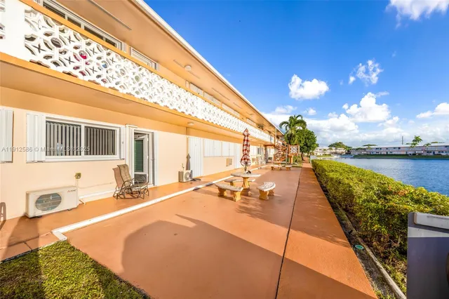 a swimming pool with outdoor seating and yard