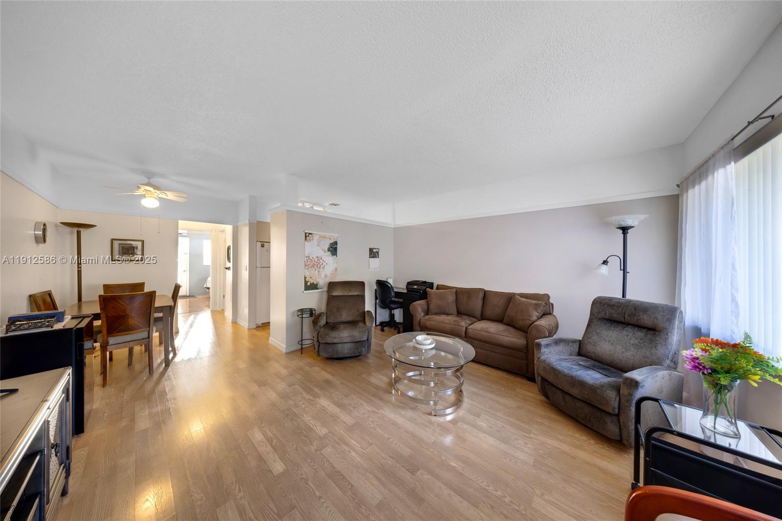 900 Southwest 10th Terrace, Unit 8S Hallandale Beach, FL 33009 - Photo 2 of 33 a living room with furniture and wooden floor