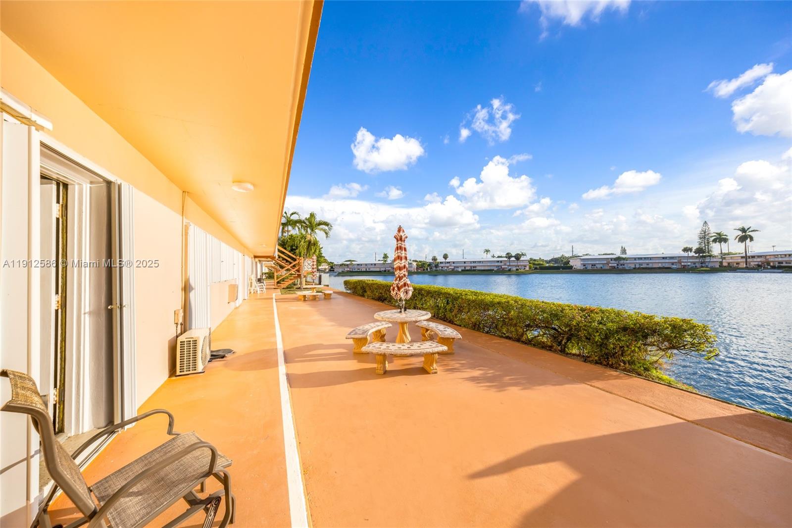 900 Southwest 10th Terrace, Unit 8S Hallandale Beach, FL 33009 - Photo 21 of 33 a view of a swimming pool with a lounge chairs
