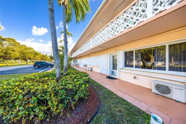 a view of a house with a yard balcony and flower plants