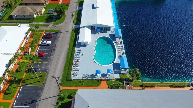 an aerial view of a house with swimming pool and outdoor space